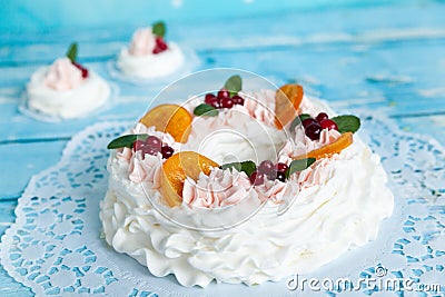 Christmas pavlova cake wreath decorated with cranberry, carmelized orange slices and mint Stock Photo