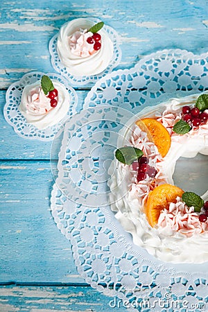 Christmas pavlova cake wreath decorated with cranberry, carmelized orange slices and mint Stock Photo