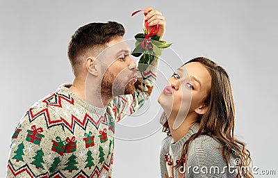 happy couple kissing under the mistletoe Stock Photo