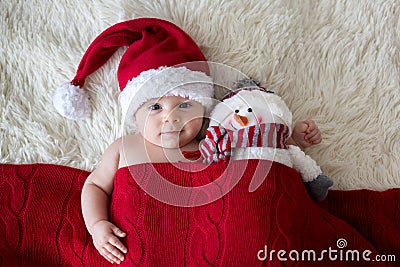 Christmas portrait of cute little newborn baby boy, wearing santa hat Stock Photo