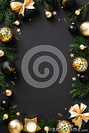 Christmas poster design. Luxury golden balls, decorations, Christmas tree branches, gift boxes on black background. Vertical New Stock Photo