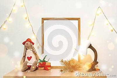 Christmas poster frame mock up. Hand made doll green fir branches red paper gift boxes lights garland lamp Stock Photo