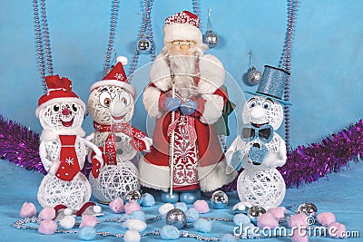 Christmas preparations of cheerful snowmen on blue festive stage Stock Photo