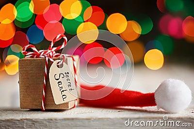 Christmas present or box for secret santa with Santa hat. Greeting card. Stock Photo