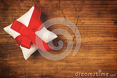 Christmas present wrapped and tied with red ribbon Stock Photo
