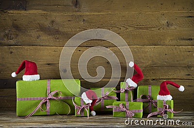 Christmas presents in apple green decorated with red santa hats Stock Photo