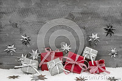 Christmas presents in red and silver on wooden grey background. Stock Photo