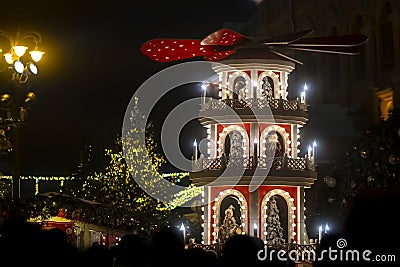 Christmas pyramid at festive street fair, night scene Stock Photo