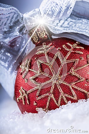 Christmas red ball or candle with golden ornaments,silver ribbon and snow. Stock Photo