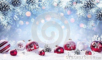 Christmas - Red Baubles On Snow Stock Photo