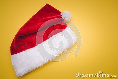 Christmas red Santa Claus hat with white pompom yellow . Decoration background Stock Photo