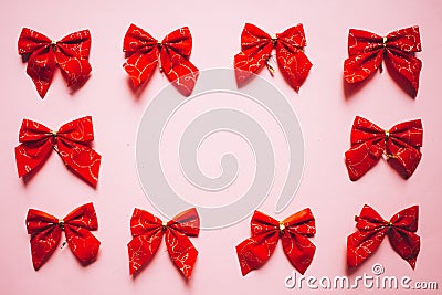 Christmas red satin bows frame, set of ribbons on pink background Stock Photo