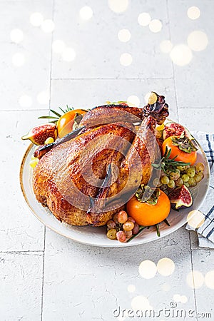 Christmas roasted whole chicken served with fruits on plate Stock Photo