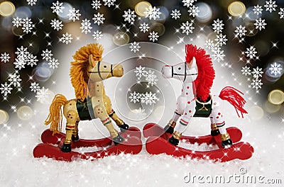 Two ornamental Christmas rocking horses facing each other with 