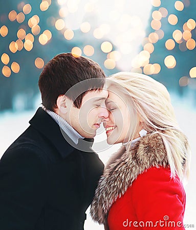 Christmas romantic sensual couple in love to cold winter over celebration bokeh, gentle kiss moment Stock Photo