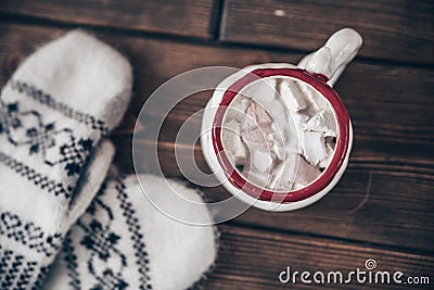 Christmas scene with mittens and hot chocolate with marshmallow Stock Photo
