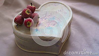 Christmas set in retro vintage style with red craft apples and handmade craft gift box in form of heart with lettering Love on Stock Photo