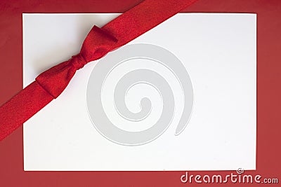 Christmas sheet of paper and red ribbon Stock Photo