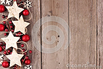 Christmas side border with rustic wood star ornaments and baubles on aged wood Stock Photo