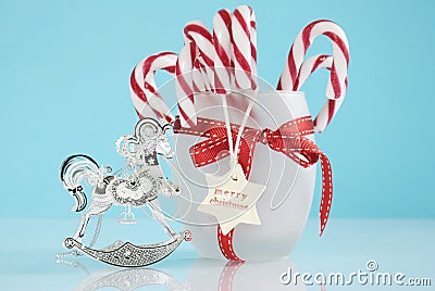 Christmas silver vintage rocking horse tree ornament and jar of candy canes Stock Photo