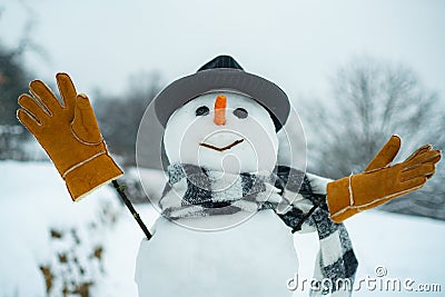 Christmas snowman close up with scarf. New Year greeting card. Christmas snowman on white snow background. Happy snowman Stock Photo