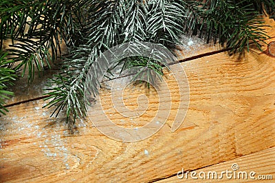 Christmas snowy tree branch on wood as background. Stock Photo