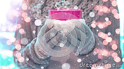 Christmas snowy winter background - Young pretty woman with gloves and scarf stands outdoor and holds a pink hot steaming teacup Stock Photo