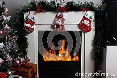 Festive Delights: Christmas Socks and Warmth by the Fireplace Stock Photo