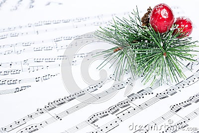 Christmas song, xmas tree branch on music sheet Stock Photo