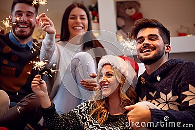 Christmas sparklers-friends enjoying party on Christmas Stock Photo