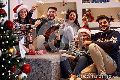 Christmas sparklers- people enjoying party on Christmas Stock Photo