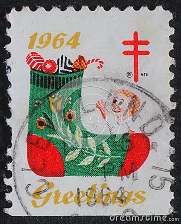 Christmas stamp printed in the USA shows a stocking with gifts Editorial Stock Photo