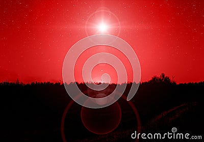 Christmas star. Background of the beautiful nite red starry sky and bright star. Stock Photo