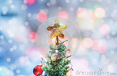 Christmas star on Christmas tree, soft Bokeh lights background Stock Photo