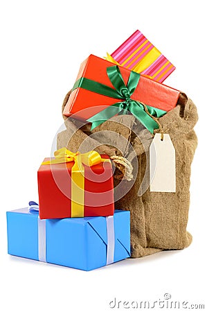 Christmas stocking or Santa sack filled with presents isolated on white background Stock Photo