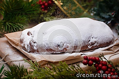 Christmas stollen its a Traditional Dresdner German Christmas cake Stollen with raising, berries and nuts. Powdered sugar is Stock Photo