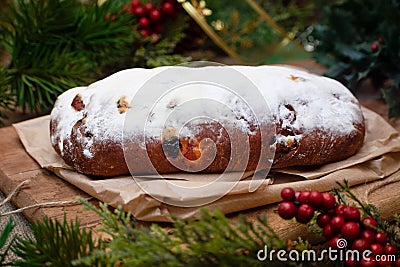 Christmas stollen its a Traditional Dresdner German Christmas cake Stollen with raising, berries and nuts. Christmas decorations Stock Photo