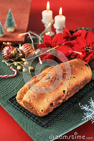 Christmas Stollen. Traditional Sweet Fruit Loaf German Bread with Icing Sugar. Xmas Holiday Table Setting, Decorated with Mini Stock Photo