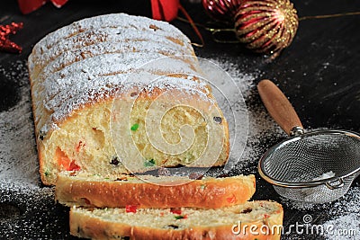 Christmas Stollen. Traditional Sweet Fruit Loaf with Icing Sugar. Xmas Holiday Table Setting, Decorated with Mini Tree Christmast Stock Photo