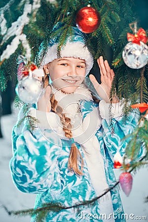Christmas story. happy little girl smiling near christmas tree with toys Stock Photo