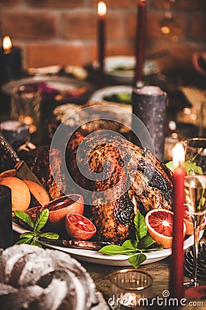 Christmas table with roasted turkey, chocolate cake and candles Stock Photo