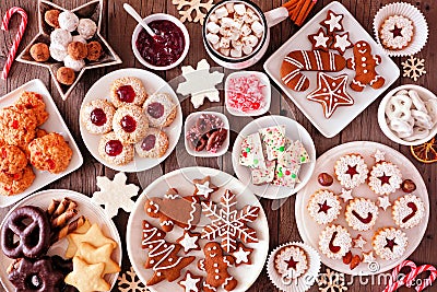 Christmas baking table scene with assorted sweets and cookies, top view over a rustic wood background Stock Photo