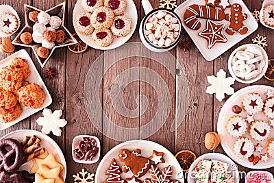 Christmas baking table scene of mixed sweets and cookies, above view over a rustic wood background Stock Photo