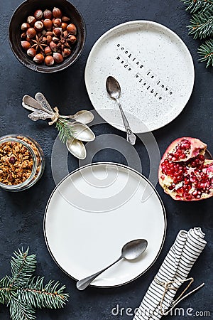 Christmas Table setting with empty white plates, vintage tea spoons, napkin Stock Photo