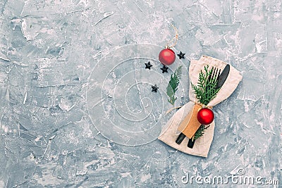 Christmas table setting. Napkin, fork and knife with decorations. Stock Photo