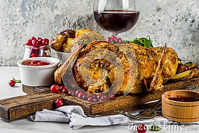 Christmas, thanksgiving food, baked roasted chicken with cranberry and herbs, served with fried vegetables, fresh berries wine Stock Photo