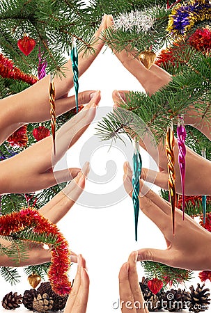 Christmas themed concept of hands making a Christmas tree shape framed with branches and ornaments Stock Photo