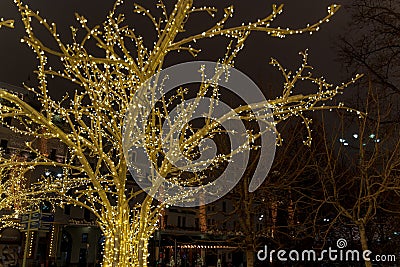 Christmas time city decoration. Lights and toys on the city street during winter holiday season. Festive illuminations in the Stock Photo