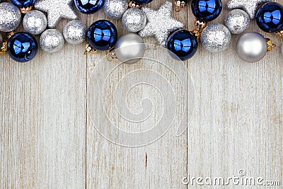 Christmas top border of blue and silver ornaments on gray wood Stock Photo