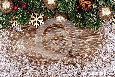 Christmas top border with gold ornaments, branches and snow Stock Photo